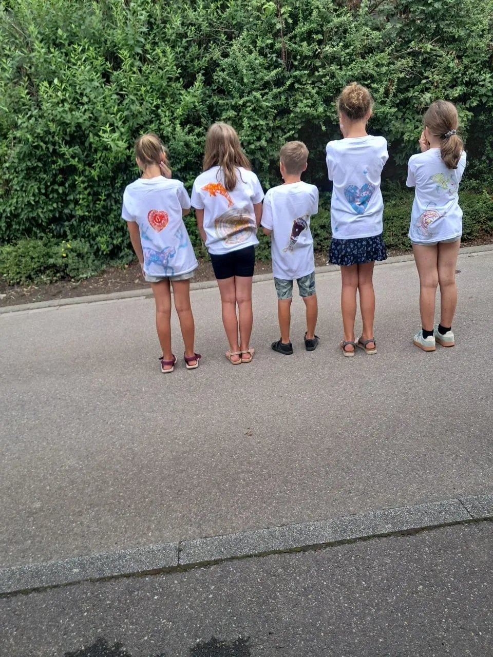 Fünf Kinder von hinten in ihren selbst gestalteten T-Shirts